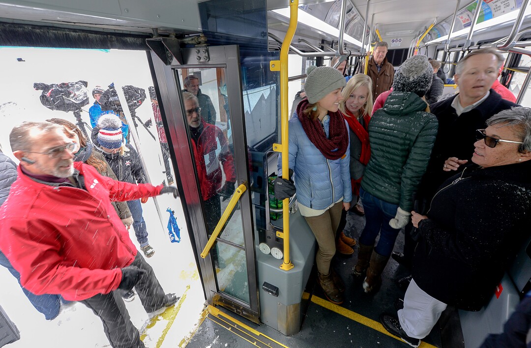 (Francisco Kjolseth  |  The Salt Lake Tribune)  UTA and Central Wasatch Commission members gather at the Big Cottonwood Canyon park and ride lot on Monday, Nov. 25, 2019, as the snow flies to remind residents about improvements to ski buses that will begin service on Nov. 29.