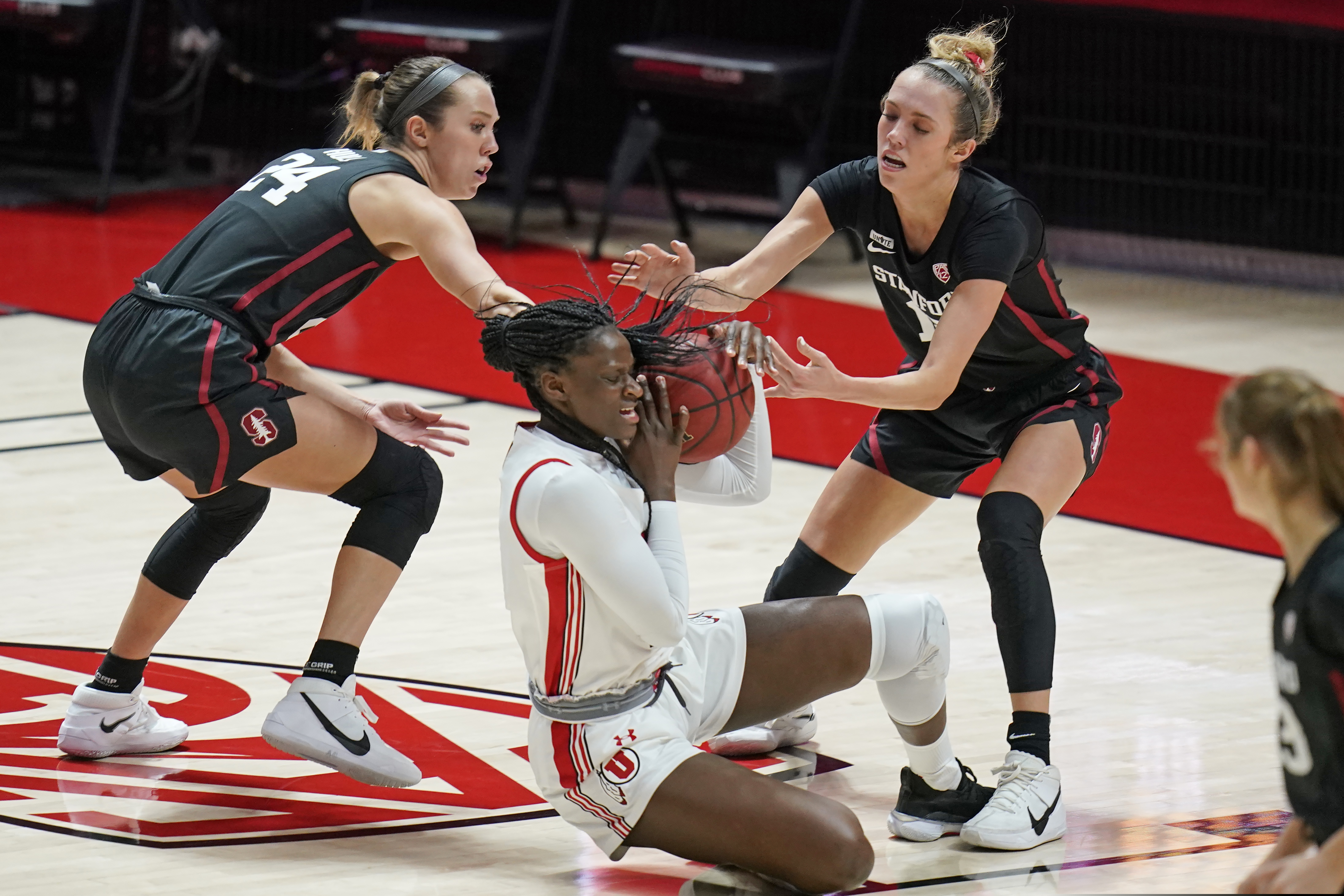 Stanford's Lacie Hull (24) and Lexie Hull, right, defend against Utah forward Lola Pendande (12) in the first half during an NCAA college basketball game Friday, Jan. 15, 2021, in Salt Lake City. (AP Photo/Rick Bowmer)