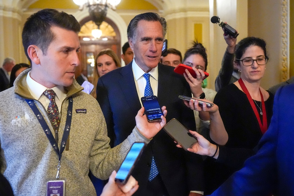 (Mark Schiefelbein | The Associated Press) Sen. Mitt Romney, R-Utah, speaks with members of the media as he walks Wednesday, Feb. 28, 2024, at the Capitol in Washington.