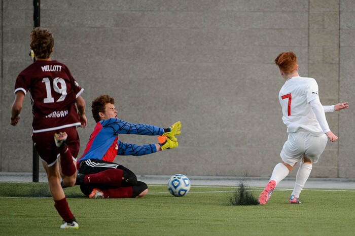 (Trent Nelson | The Salt Lake Tribune)  Judge Memorial's Joseph Paul scores the game-winning goal against Morgan goalkeeper Trek Loveridge in the 3A state championship game, Saturday May 12, 2018.