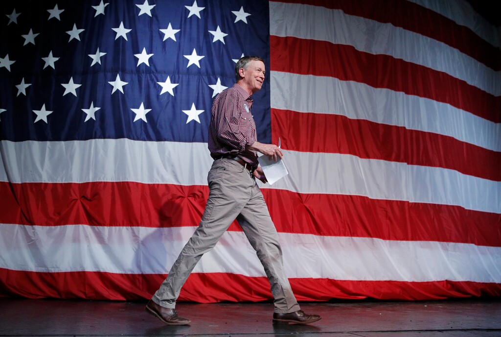 (John Locher | AP file photo) Democratic presidential candidate and former Colorado Gov. John Hickenlooper walks on stage before speaking at the Iowa Democratic Wing Ding at the Surf Ballroom, Friday, Aug. 9, 2019, in Clear Lake, Iowa.