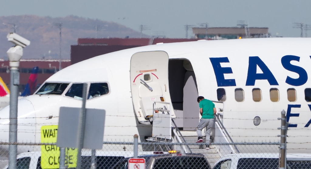 (Chris Samuels | The Salt Lake Tribune) Detainees believed to be in the custody of Immigration and Customs Enforcement board a plane at Salt Lake City International Airport, Monday, April 6, 2026.