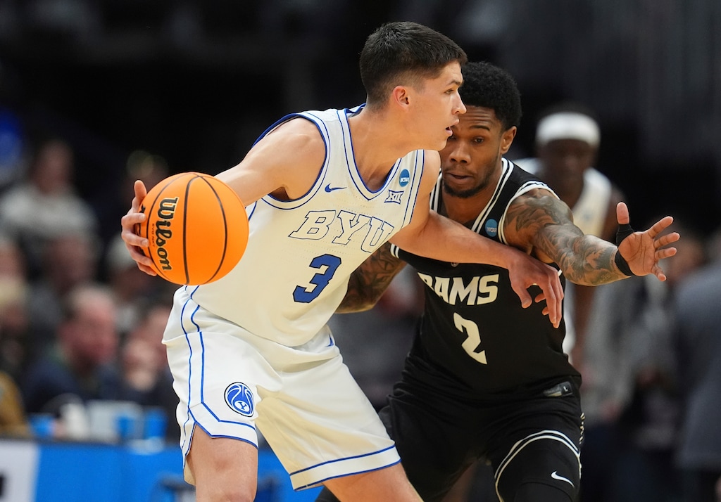 (David Zalubowski | AP) BYU guard Egor Demin, left, looks to pass the ball as Virginia Commonwealth guard Zeb Jackson defends during the first half in the first round of the NCAA college basketball tournament Thursday, March 20, 2025, in Denver.