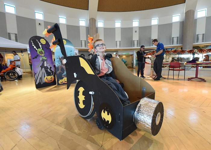(Francisco Kjolseth  |  The Salt Lake Tribune)  Ethan Clegg, 8, is all smiles after getting a spin in his new Batmobile as volunteers and staff at Shriners Hospital for Children in Salt Lake transform the wheelchairs of 28 patients for Halloween, Wednesday, Oct. 17, 2018.