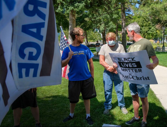 (Leah Hogsten | The Salt Lake Tribune) Colton Welch, left, and his father Ken Welch, right, talk with a fellow supporters at Back the Blue rally in support of law enforcement, Saturday, August 15, 2020 at Washington Square.