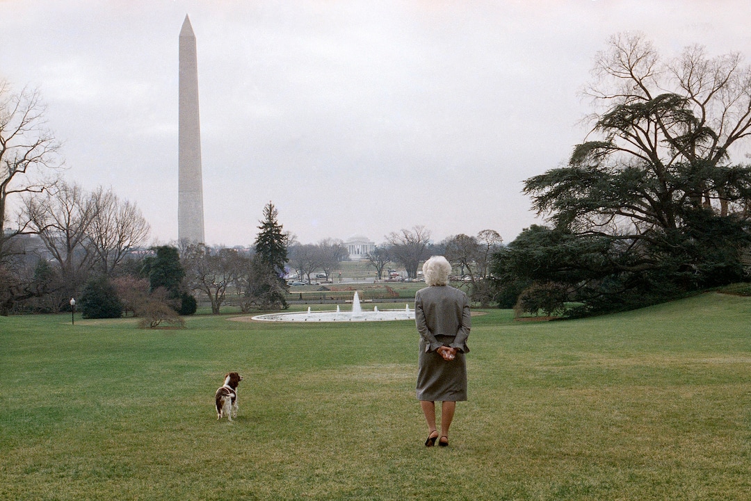 FILE - In this Feb. 8, 1989, file photo, first lady Barbara Bush strolls on the White House South Lawn in Washington, with the family dog, Millie. A family spokesman said Tuesday, April 17, 2018, that former first lady Barbara Bush has died at the age of 92. (AP Photo/Barry Thumma, File)