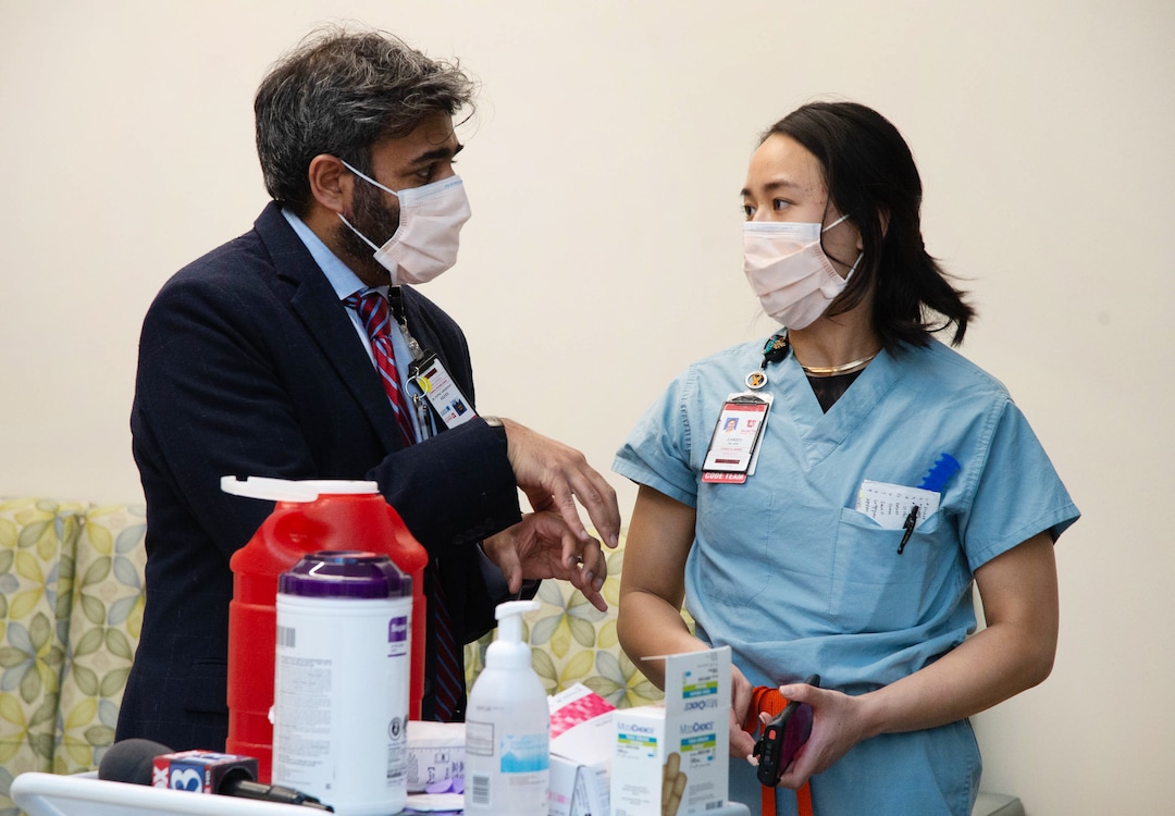 (Francisco Kjolseth  | The Salt Lake Tribune) Kavish Choudhary, PharmD, Senior Director, U of U Health Pharmacy, left, speaks with Christy Mulder, RN, MICU, following her second dose of the Pfizer-BioNTech COVID-19 vaccine on Thursday, Jan. 7, 2021.