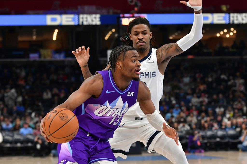 Utah Jazz guard Isaiah Collier (13) handles the ball against Memphis Grizzlies guard Ja Morant in the first half of an NBA basketball game, Saturday, Jan. 25, 2025, in Memphis, Tenn. (AP Photo/Brandon Dill)