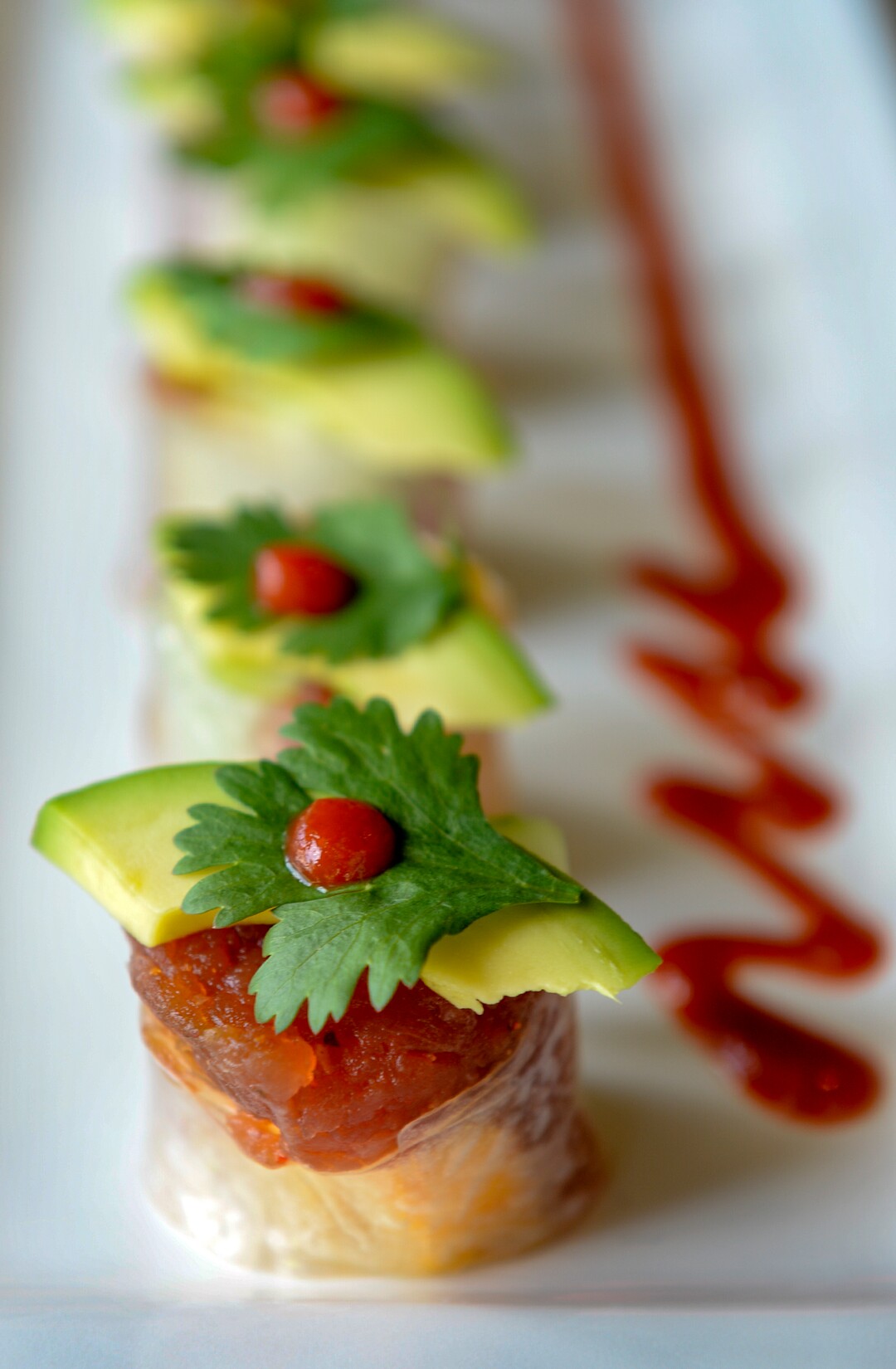 (Leah Hogsten  |  The Salt Lake Tribune)  Saola's Covered Bridge Spring Maki roll made with rice paper, spicy tuna, mango, cucumber, topped with avocado, cilantro, nori and sriracha, $15.  Saola restaurant, located in Cottonwood Heights, serves Vietnamese food using locally sourced ingredients.
