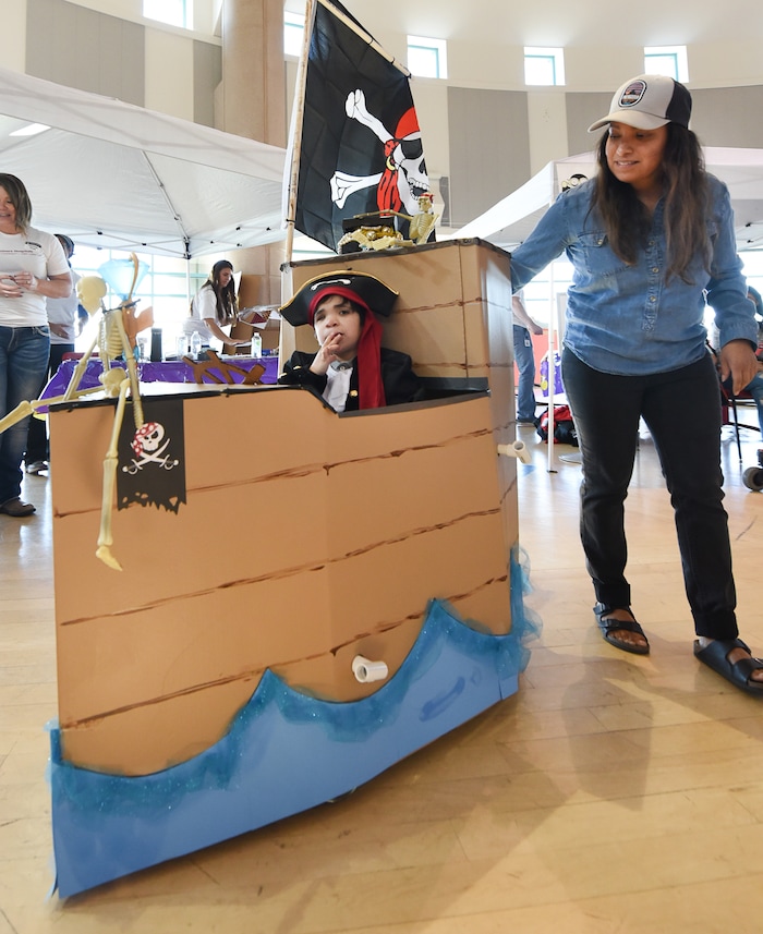 (Francisco Kjolseth  |  The Salt Lake Tribune)  Kayden Matagi, 7, takes his pirate ship for a spin with the help of his mother, Shellise, as volunteers and staff at Shriners Hospital for Children in Salt Lake transform the wheelchairs of 28 patients for Halloween, Wednesday, Oct. 17, 2018.