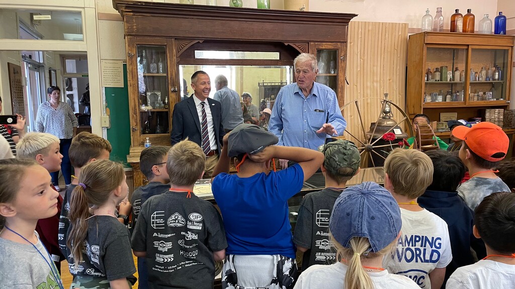 (Alastair Lee Bitsóí | Salt Lake Tribune) Washington City Mayor Kress Staheli, left, listens to local Pioneer history with students from Sandstone Elementary during its annual Cotton Days Celebration in downtown Washington City. WalletHub ranked the city as the top best small city for business opportunities.