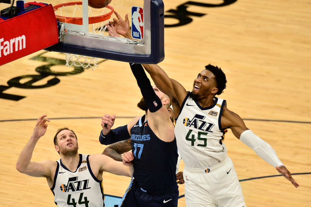 Memphis Grizzlies center Jonas Valanciunas (17) shoots against Utah Jazz guard Donovan Mitchell (45) and forward Bojan Bogdanovic (44) in the first half of Game 4 of an NBA basketball first-round playoff series Monday, May 31, 2021, in Memphis, Tenn. (AP Photo/Brandon Dill)