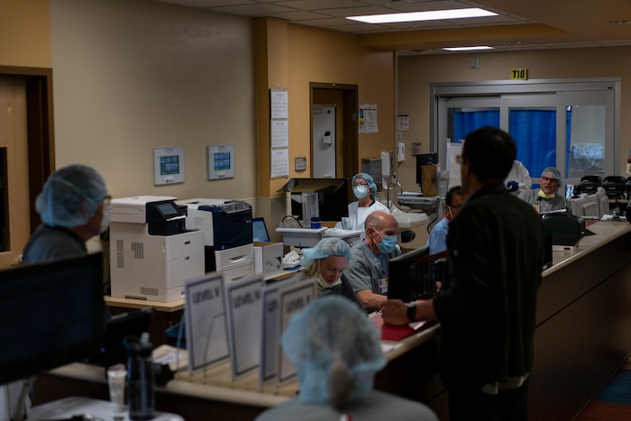 Team Rubicon volunteers work with local medical staff in the emergency room of the Kayenta Health Center on the Navajo reservation in Kayenta, Ariz., on April 23, 2020. The Navajo reservation has some of the highest rates of coronavirus in the country. Team Rubicon is helping with medical operations as cases of COVID-19 surge. (AP Photo/Carolyn Kaster)