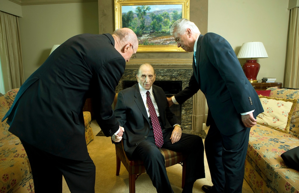 (Photo courtesy of The Church of Jesus Christ of Latter-day Saints) President Thomas S. Monson shakes hands with counselors President Henry B. Eyring and President Dieter F. Uchtdorf on Tuesday, Aug. 15, 2017, in his Salt Lake City apartment as he nears his 90th birthday on August 21, 2017.