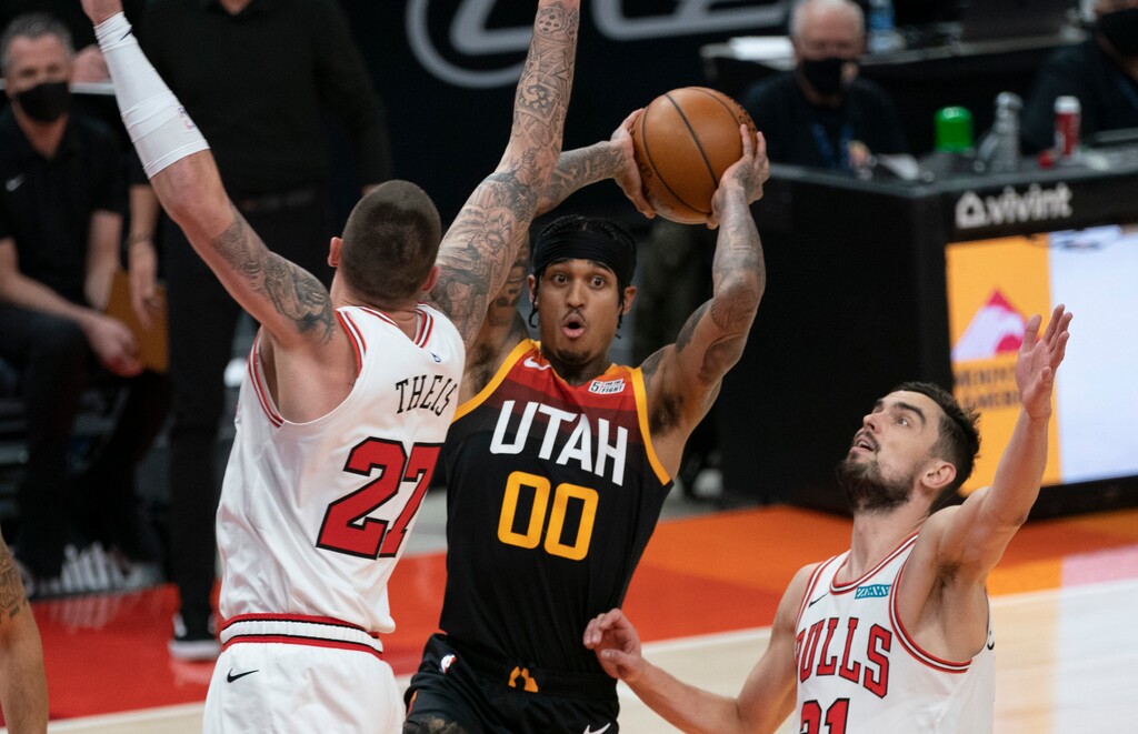 (Rick Egan | The Salt Lake Tribune) Utah Jazz guard Jordan Clarkson (00) looks to pass, as Chicago Bulls center Daniel Theis (27) defends, in NBA action between the Utah Jazz and the Chicago Bulls, at Vivint Arena, on Friday, April 2, 2021.