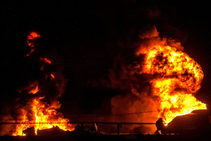 (Chris Detrick  |  The Salt Lake Tribune)  A semitrailer hauling thousands of gallons of fuel burns on Interstate-15 in Midvale Thursday, January 18, 2018.   Lt. Todd Royce of the Utah Highway Patrol said the truck was southbound on the interstate at 7500 South at 7:20 p.m. when a tire caught fire, sending flames toward the tanks.