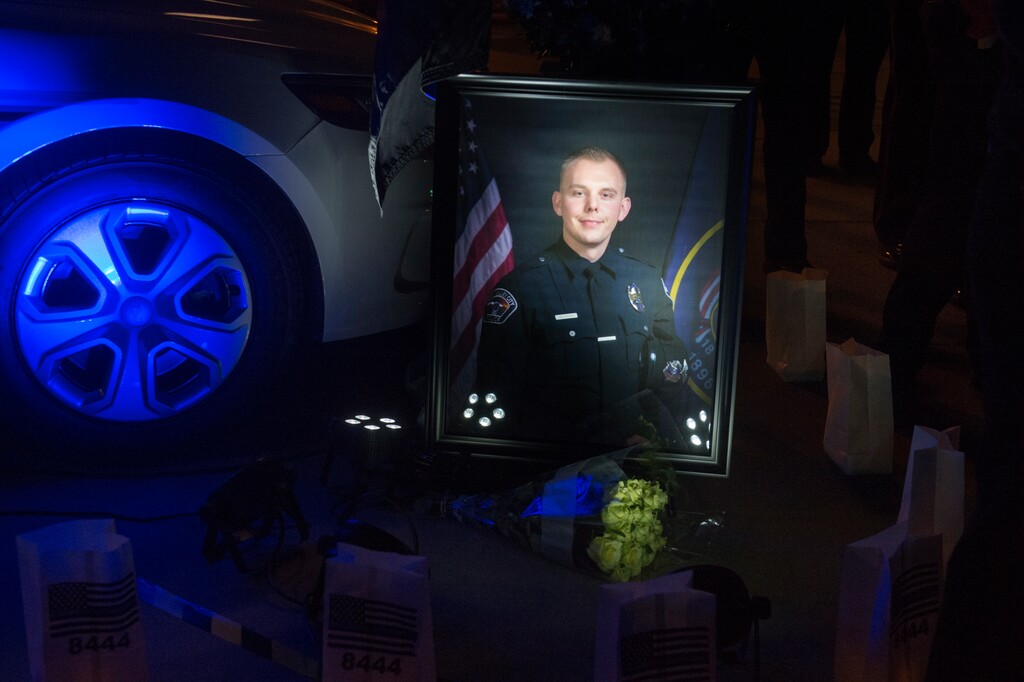(Rick Egan  |  Tribune file photo) A photo of West Valley City Officer Cody Brotherson during a memorial ceremony at Fairbourne Station Plaza in West Valley City, Nov. 6, 2017. Brotherson's mother was on Utah's Capitol Hill on Wednesday testifying on behalf of a bill that would close a loophole that resulted in her son's assailant being released early.