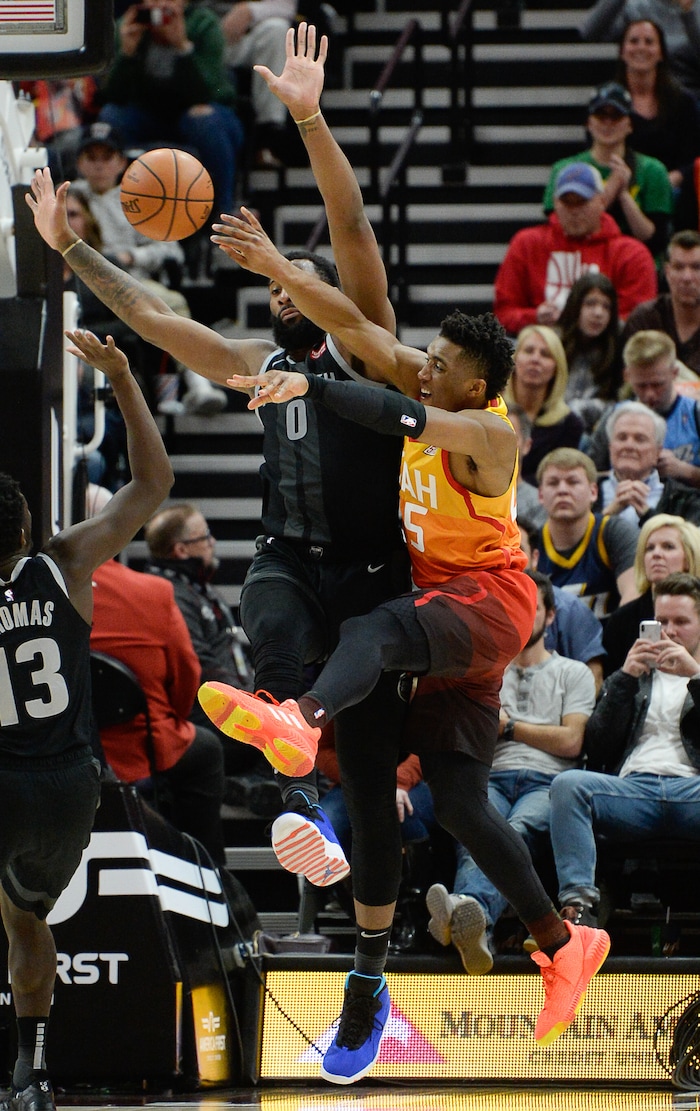 (Francisco Kjolseth  |  The Salt Lake Tribune)  Utah Jazz guard Donovan Mitchell (45) tries to get the ball past Detroit Pistons center Andre Drummond (0) in the second half of their NBA game at Vivint Smart Home Arena Monday, Jan. 14, 2019, in Salt Lake City.