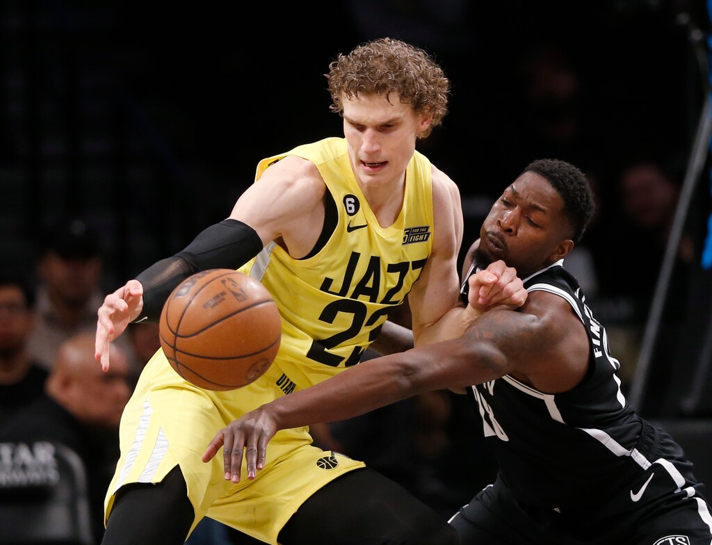 Utah Jazz forward Lauri Markkanen, left, and Brooklyn Nets forward Dorian Finney-Smith battle for the ball during the first half of an NBA basketball game Sunday, April 2, 2023, in New York. (AP Photo/John Munson)