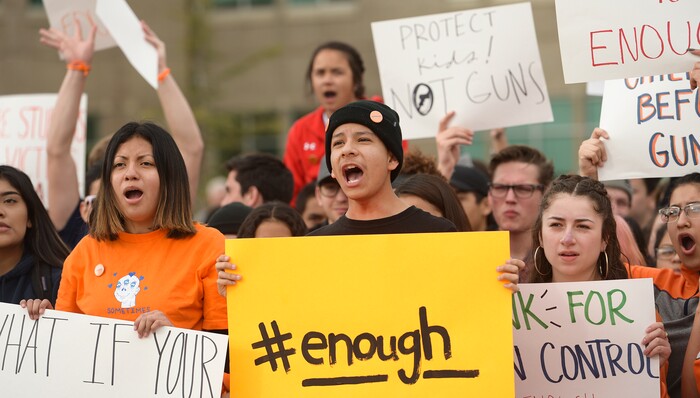 (Leah Hogsten  |  The Salt Lake Tribune) East High School student Brandon Garcia and his classmates call for change on the front lawn of the school. Exactly one month after 17 people were killed at Marjory Stoneman Douglas High School in Parkland, survivors of the massacre joined tens of thousands of students across the United States by walking out of school, Wednesday, March 14, 2018. 