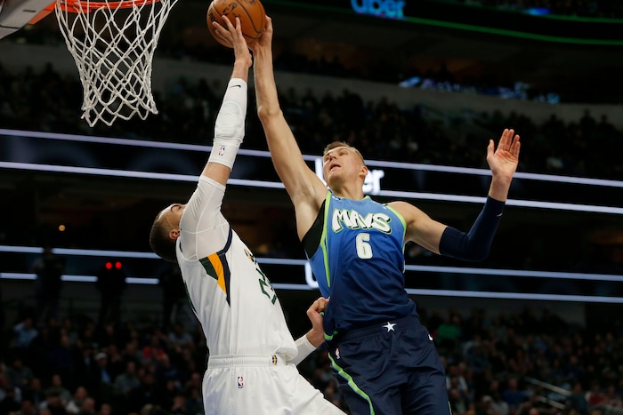 Utah Jazz center Rudy Gobert (27) blocks a shot by Dallas Mavericks forward Kristaps Porzingis (6) during the first half an NBA basketball game in Dallas, Monday, Feb. 10, 2020. (AP Photo/Michael Ainsworth)