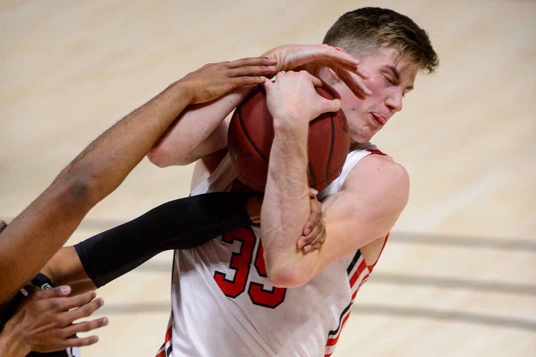(Trent Nelson  |  The Salt Lake Tribune) Utah Utes center Branden Carlson (35) pulls the ball away from Colorado Buffaloes forward Jeriah Horne (41) as Utah hosts Colorado, NCAA basketball in Salt Lake City on Monday, Jan. 11, 2021.