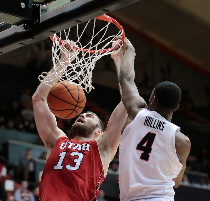 Utah's David Collette (13) dunks past Oregon State's Alfred Hollins (4) during the second half of an NCAA college basketball game in Corvallis, Ore., Sunday, Dec. 31, 2017. Utah won 66-64. (AP Photo/Timothy J. Gonzalez)