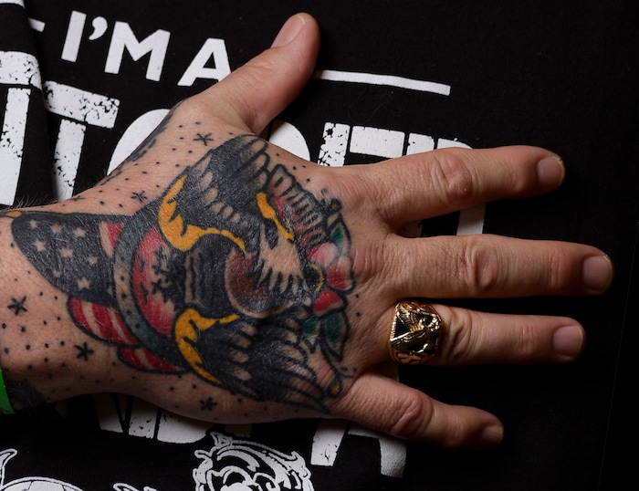(Leah Hogsten | The Salt Lake Tribune) Dennis Peterson of Boise, ID shows off his most prized tattoo on his hand that represents his service in the United States Navy from 1974-1978 at the Salt Lake City International Tattoo Convention, Saturday, March 17, 2018.