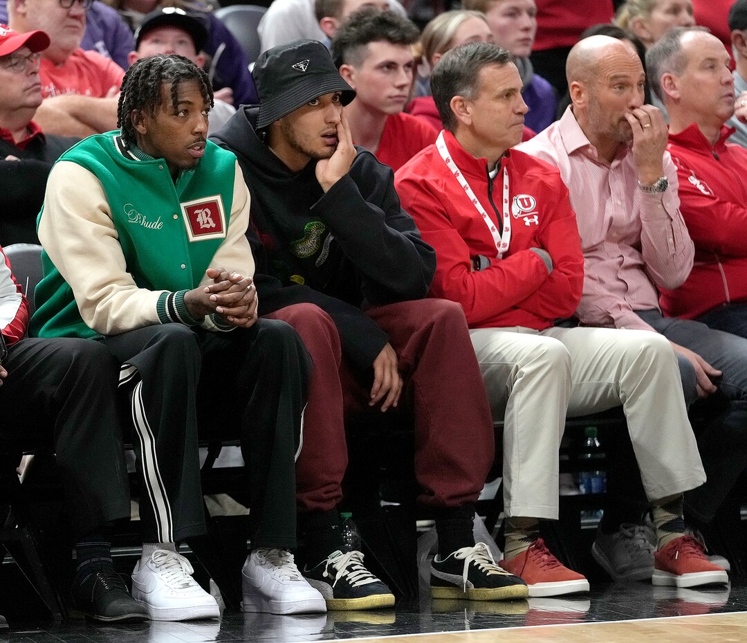 (Leah Hogsten | The Salt Lake Tribune) From left, former Ute players Delon Wright and Kyle Kuzma, both players with the Washington Wizards in town to play the Jazz on Thursday, watch as the University of Utah hosts the TCU Horned Frogs at Vivint Arena, Dec. 21, 2022. 