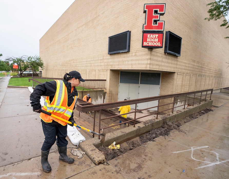 (Rick Egan | The Salt Lake Tribune) Workers clear mud and debris from the stairs leading to the gymnasium at East High School, on Monday, Aug. 2, 2021.
