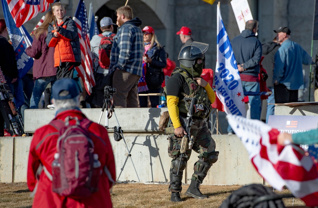 (Francisco Kjolseth  | The Salt Lake Tribune) A heavily armed member of the Proud Boys, a far-right, neo-fascist organization  walks amongst Trump supporters listening to speeches at the State Capitol in Salt Lake City on Wednesday, Jan. 6, 2021.