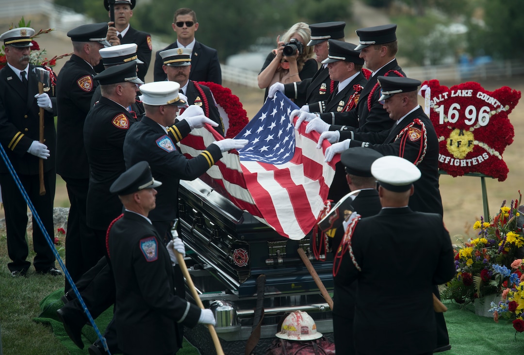 (Rick Egan  |  The Salt Lake Tribune)  The flag on the casket of Matthew Burchett is folded by the pall bearers at East Lawn Memorial Hills Cemetery in Provo, Monday, Aug. 20, 2018.