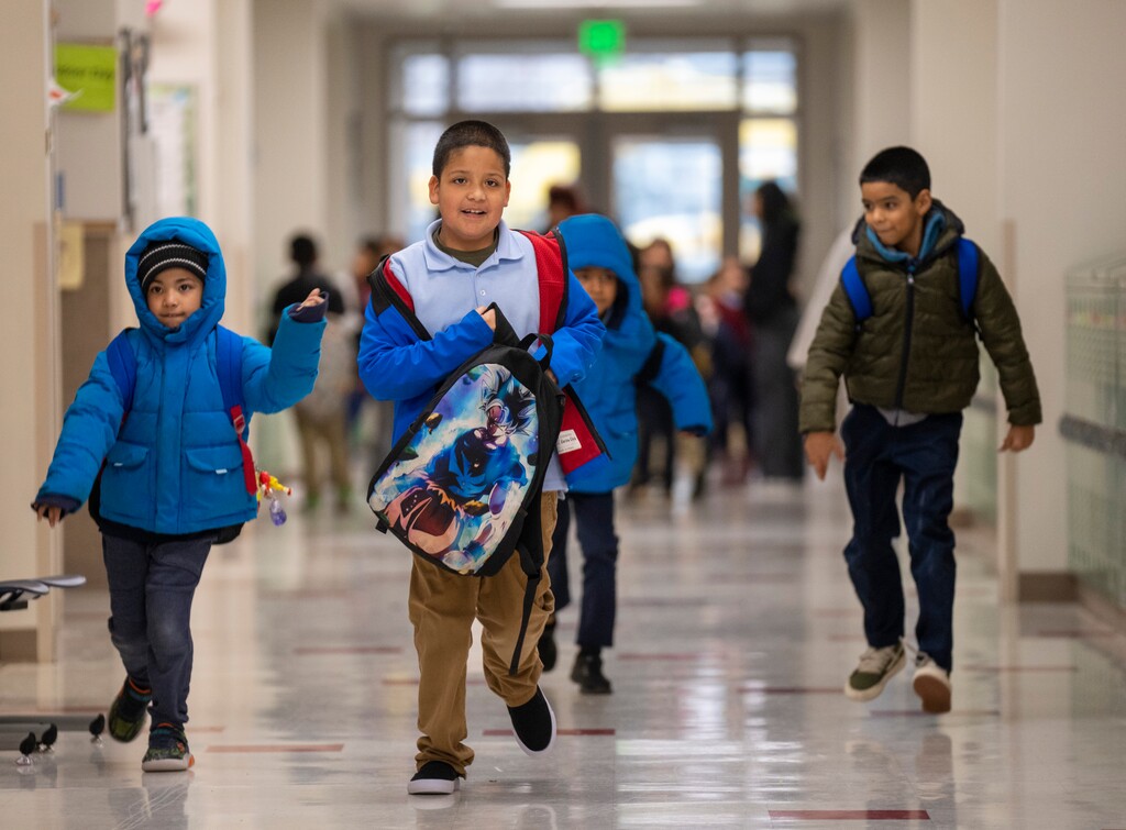 (Rick Egan | The Salt Lake Tribune) Julian Robles, Elijah Garza, and Aaron Lopez Ayala walk down the hallway at Guadalupe School, on Thursday, March 7, 2024. The school serves immigrant families and feels confident in its mission despite Utah's anti-DEI law. “Where our concerns lie are with the futures of the demographics we serve," an administrator said.