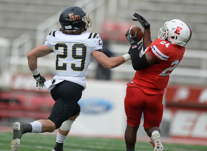 (Francisco Kjolseth | The Salt Lake Tribune) Jacob Mumford of Lone Peak puts the pressure on Jaylon Vickers of East in their class 6A semifinal game at Rice-Eccles Stadium, Friday, Nov. 10, 2017.