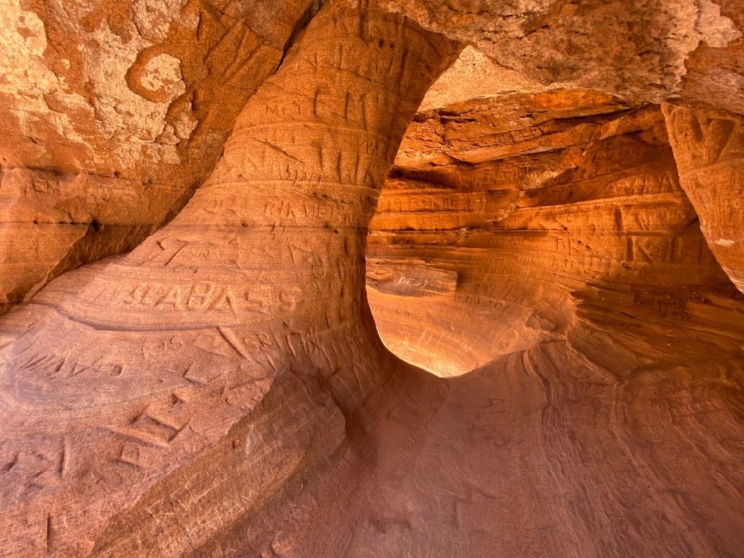 (Photo courtesy of the National Park Service) Carved names in a sandstone alcove at Zion National Park.