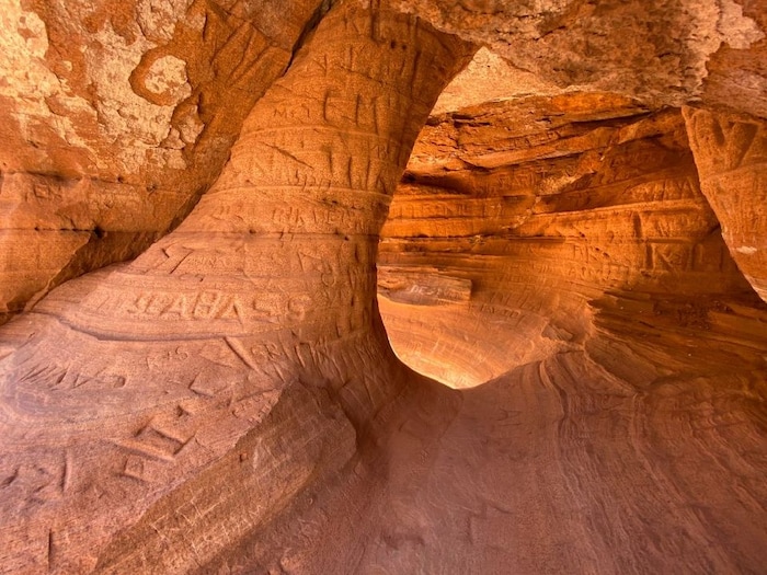 (Photo courtesy of the National Park Service) Carved names in a sandstone alcove at Zion National Park.