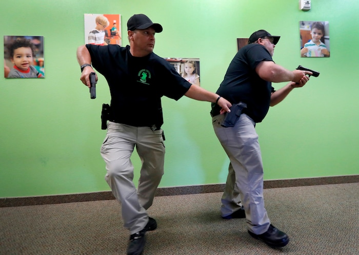 (Tony Gutierrez | AP Photo) In this July 21, 2019 photo, Chris Scott, left, and Charles White, right, slowly walk down a hallway as they clear the area during a security training session at Fellowship of the Parks campus in Haslet, Texas. An industry has sprung up following mass shootings at houses of worship around the country to train civilians to protect their churches with the techniques and equipment of law enforcement.