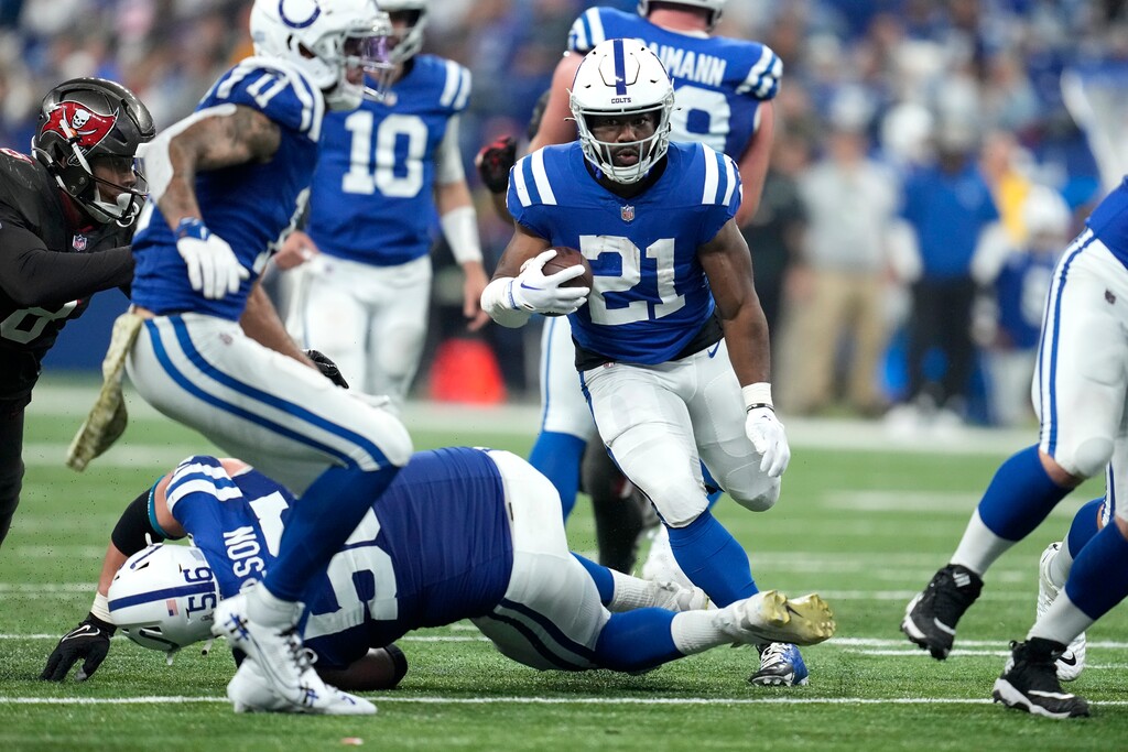 Indianapolis Colts running back Zack Moss (21) runs the ball during the second half of an NFL football game against the Tampa Bay Buccaneers Sunday, Nov. 26, 2023, in Indianapolis. (AP Photo/Michael Conroy)