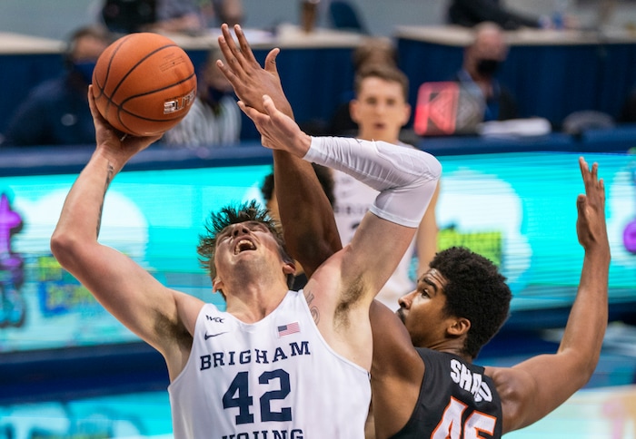 (Rick Egan | The Salt Lake Tribune) Brigham Young Cougars center Richard Harward (42) shoots, as Pacific Tigers forward Nigel Shadd (45) defends, in basketball action at the Marriott Center in Provo, on Saturday, Jan. 30, 2021.