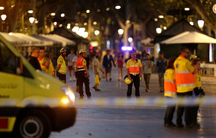 (Manu Fernandez | The Associated Press) Emergency workers stand on a blocked street in Barcelona, Spain, Thursday, Aug. 17, 2017. A white van jumped up onto a sidewalk and sped down a pedestrian zone Thursday in Barcelona's historic Las Ramblas district, swerving from side to side as it plowed into tourists and residents. Police said 13 people were killed and more than 50 wounded in what they called a terror attack.