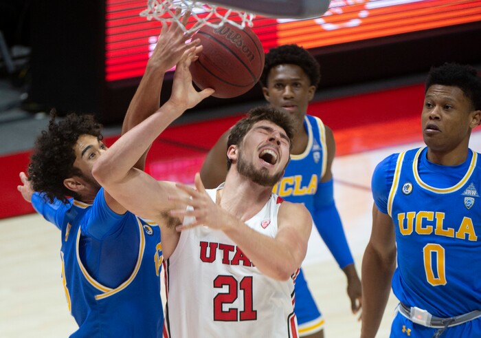 (Rick Egan | The Salt Lake Tribune) UCLA Bruins guard Johnny Juzang (3), goes for the ball along with Utah Utes forward Riley Battin (21), in PAC-12 basketball action at the Jon M. Huntsman Center, on Thursday, Feb. 25, 2021.