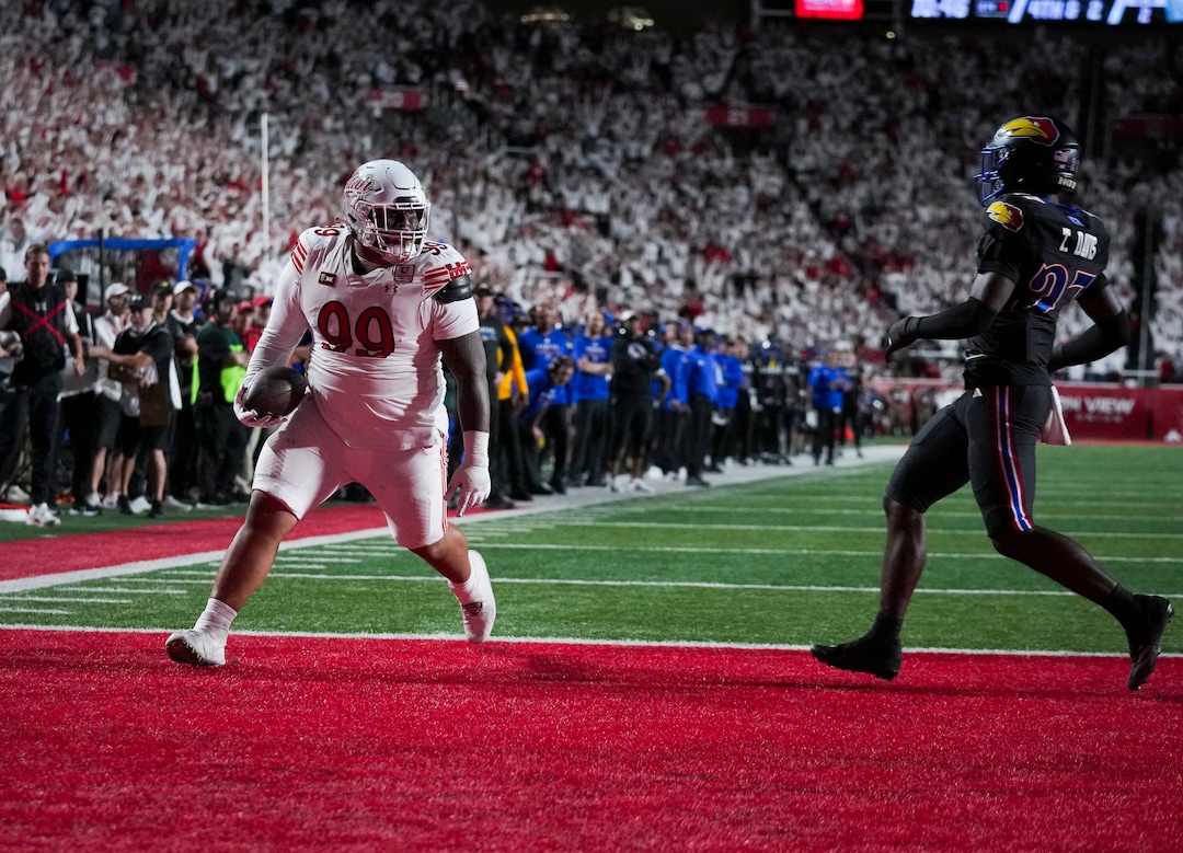 (Bethany Baker  |  The Salt Lake Tribune) Utah Utes tight end Semi Taulanga (99) runs the ball into the end zone for a touchdown as Kansas Jayhawks safety Taylor Davis (27) defends during the game between the Utah Utes and the Kansas Jayhawks at Rice-Eccles Stadium in Salt Lake City on Saturday, Oct. 10, 2026.