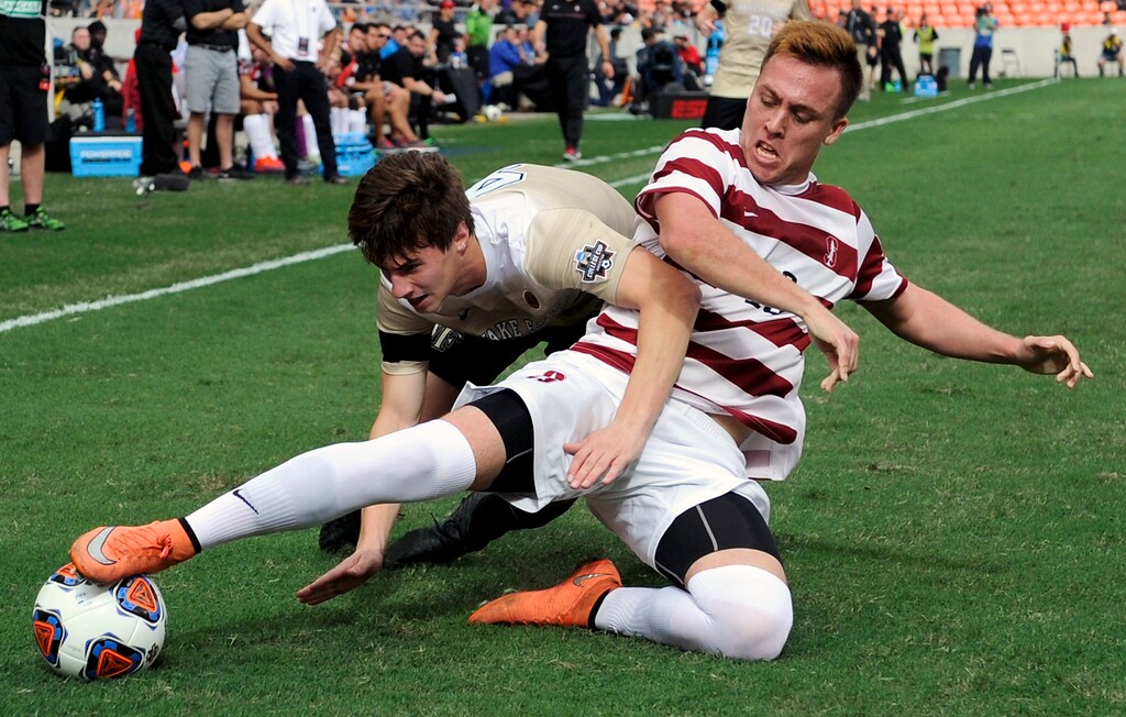 Stanford forward Corey Baird, right, and Wake Forest defender Kevin Politz collide while going for the ball during the first half of an NCAA college soccer game, Sunday, Dec. 11, 2016, in Houston. (AP Photo/Eric Christian Smith)