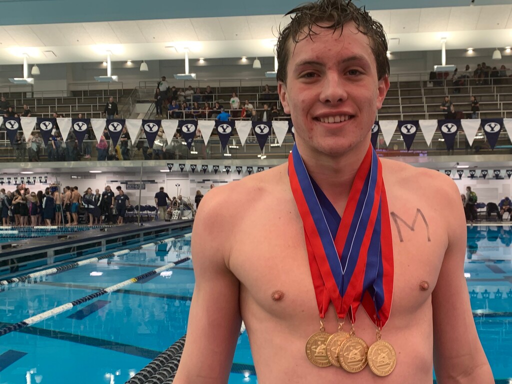 (Alex Vejar | The Salt Lake Tribune) Lone Peak junior Jordan Tiffany stands with four gold medals around his neck representing the 6A state championships he won at the swimming finals Saturday at Brigham Young University. He set two overall state records on during the event.