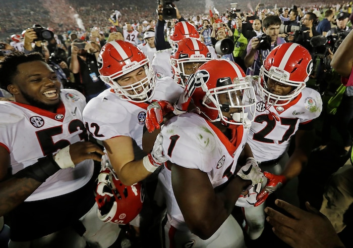 Georgia tailback Sony Michel (1) celebrates with teammates after scoring the game-winning touchdown in the second overtime period to give Georgia a 54-48 win over Oklahoma in the Rose Bowl NCAA college football game, Monday, Jan. 1, 2018, in Pasadena, Calif (AP Photo/Doug Benc)
