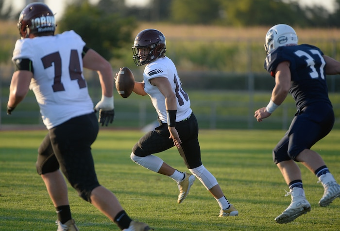 (Francisco Kjolseth  |  The Salt Lake Tribune)  Jordan quarterback Crew Wakley looks for an open teammate against Syracuse on Thursday, Aug. 24, 2017.