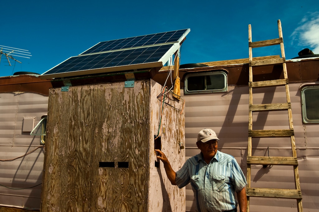 (Chris Detrick | Tribune file photo) In this 2010 file photo, Albert Cly, 71, shows off the solar electricity panels he installed in his home in the Westwater Navajo community. The 16 residents of Westwater live without running water or electricity, despite the community's proximity to Blanding.
