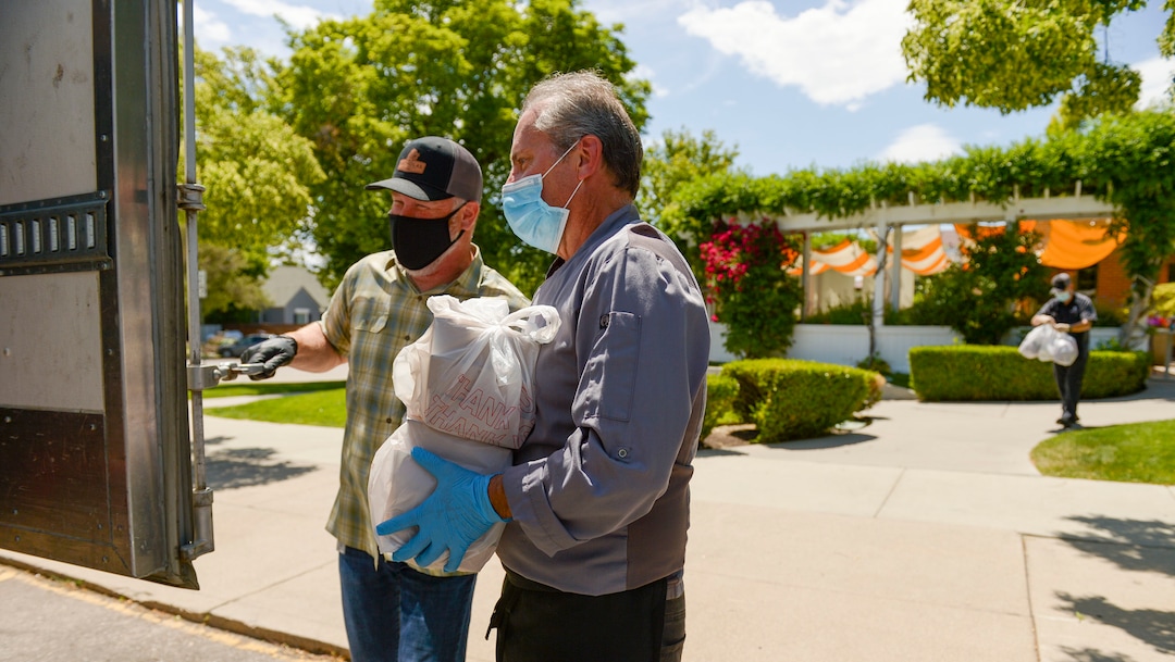(Leah Hogsten  |  The Salt Lake Tribune) l-r Nicholas & Co. sales vice-president Scott Albert and Trio restaurant owner Mikel Trapp load 27 boxes of food for transport to feed frontline workers June 3, 2020. Since March, the Helping Heroes program, launched by Utah restaurant food supplier, Nicholas & Co., has been taking food originally planned for restaurants and using it to feed frontline COVID-19 workers across the Wasatch Front.