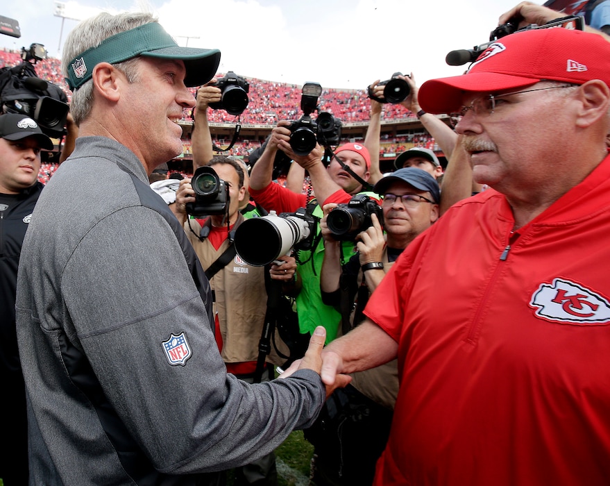 Philadelphia Eagles coach Doug Pederson, left, talks to Kansas City Chiefs coach Andy Reid after their NFL football game Sunday, Sept. 17, 2017, in Kansas City, Mo. The Chiefs won 27-20. (AP Photo/Charlie Riedel)