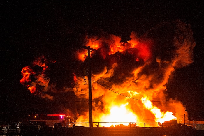 (Chris Detrick  |  The Salt Lake Tribune)  Firefighters attempt to put out a burning semitrailer that was hauling thousands of gallons of fuel on Interstate-15 in Midvale Thursday, January 18, 2018.   Lt. Todd Royce of the Utah Highway Patrol said the truck was southbound on the interstate at 7500 South at 7:20 p.m. when a tire caught fire, sending flames toward the tanks.
